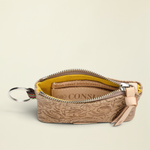 Point of Origin Consuela Lawton pouch in tan tooled leather with a yellow interior, zipper closure, and metal keyring.