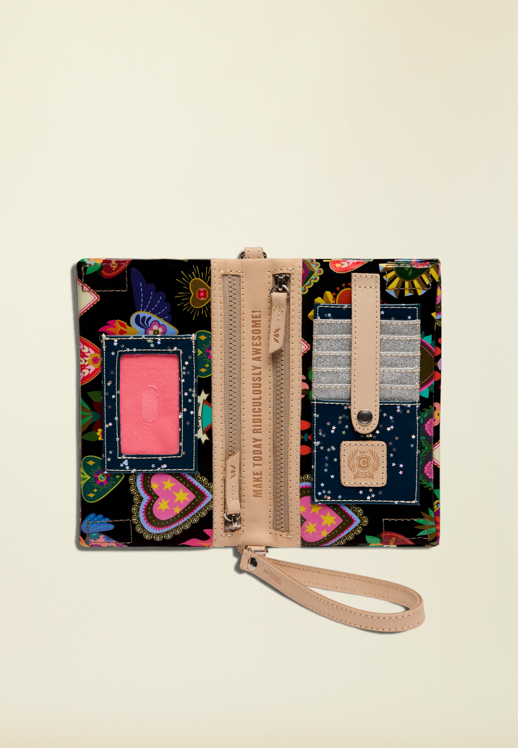 Point of Origin Consuela Vida Uptown Crossbody wallet open to show colorful heart print, card slots, and ID window.