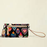 Point of Origin Consuela Vida Uptown crossbody bag in black with colorful heart print and natural leather trim.
