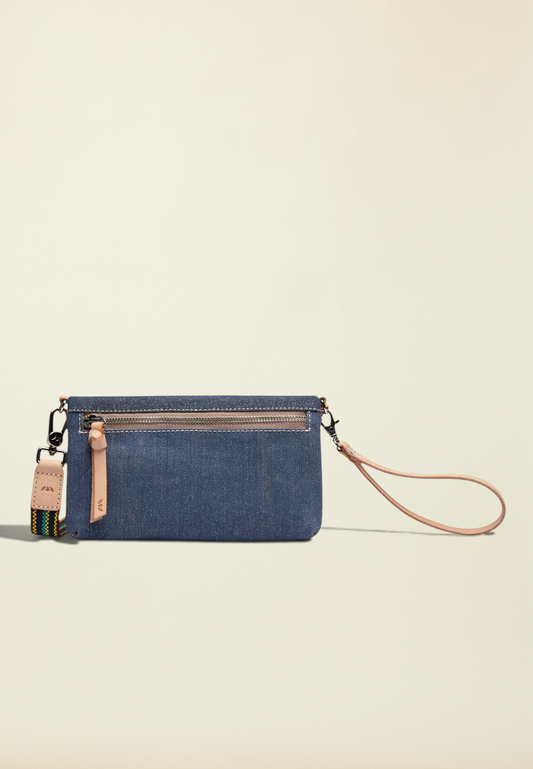 Point of Origin Uptown Crossbody Royal in layered denim with natural leather trim, wristlet strap, and woven strap.
