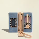 Point of Origin Uptown Crossbody Royal open interior showing denim fabric, leopard print accents, and card slots.