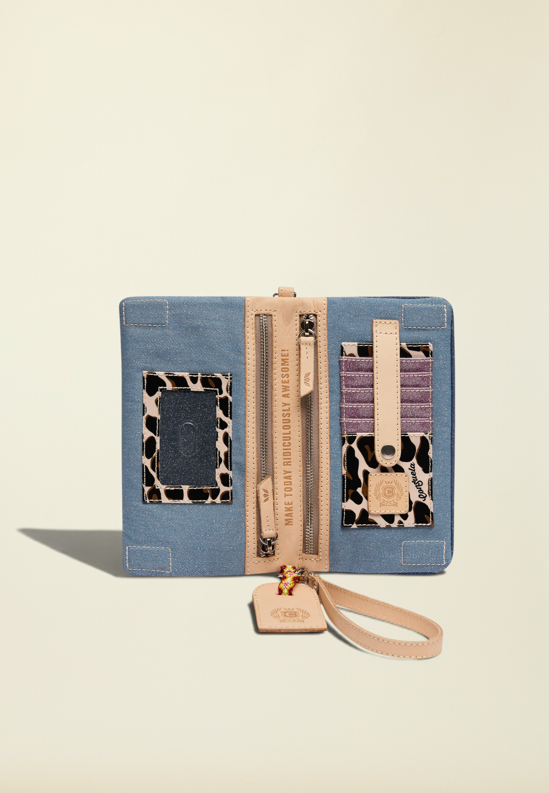 Point of Origin Uptown Crossbody Royal open interior showing denim fabric, leopard print accents, and card slots.
