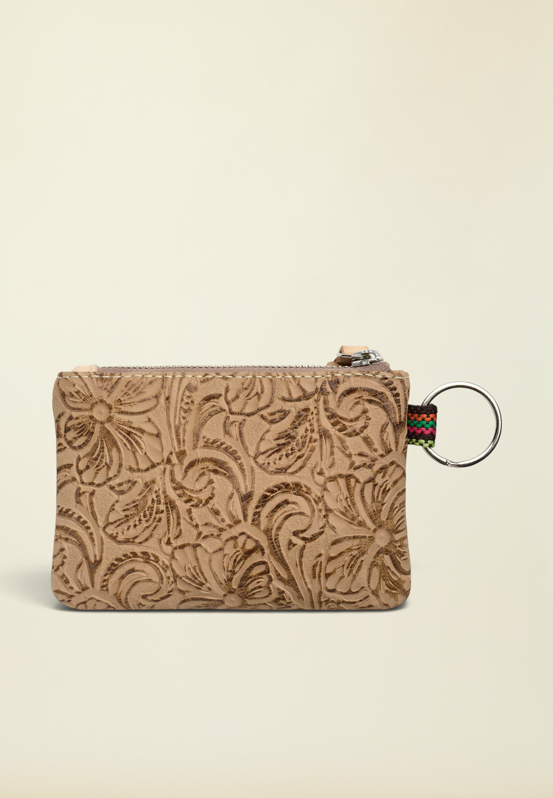 Point of Origin Consuela Lawton pouch in tan tooled leather with a floral pattern, zipper closure, and metal keyring.