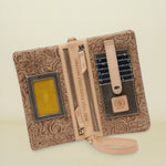 Point of Origin Lawton Uptown Crossbody wallet in tan floral embossed leather with interior card slots and zipper