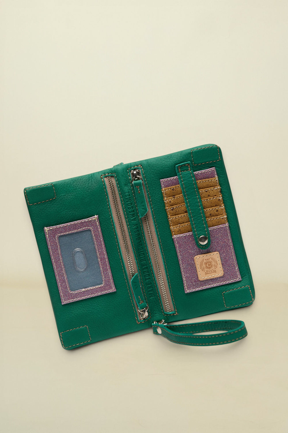 Point of Origin teal leather Uptown Crossbody wallet with interior card slots, ID window, and zipper pocket.