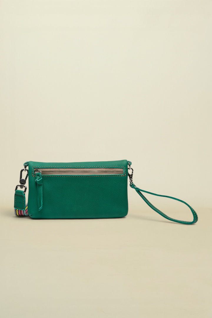 Point of Origin teal leather Uptown crossbody bag with a zippered back pocket and a detachable patterned wrist strap.