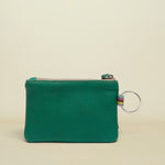 Point of Origin teal leather coin pouch with a silver zipper and a small multi-colored fabric loop with a key ring.