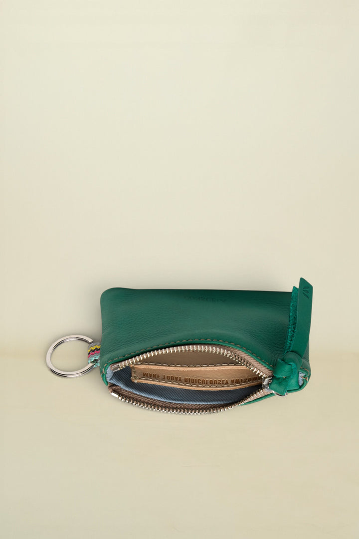 Point of Origin teal leather coin pouch with a silver zipper, key ring, and colorful woven detail