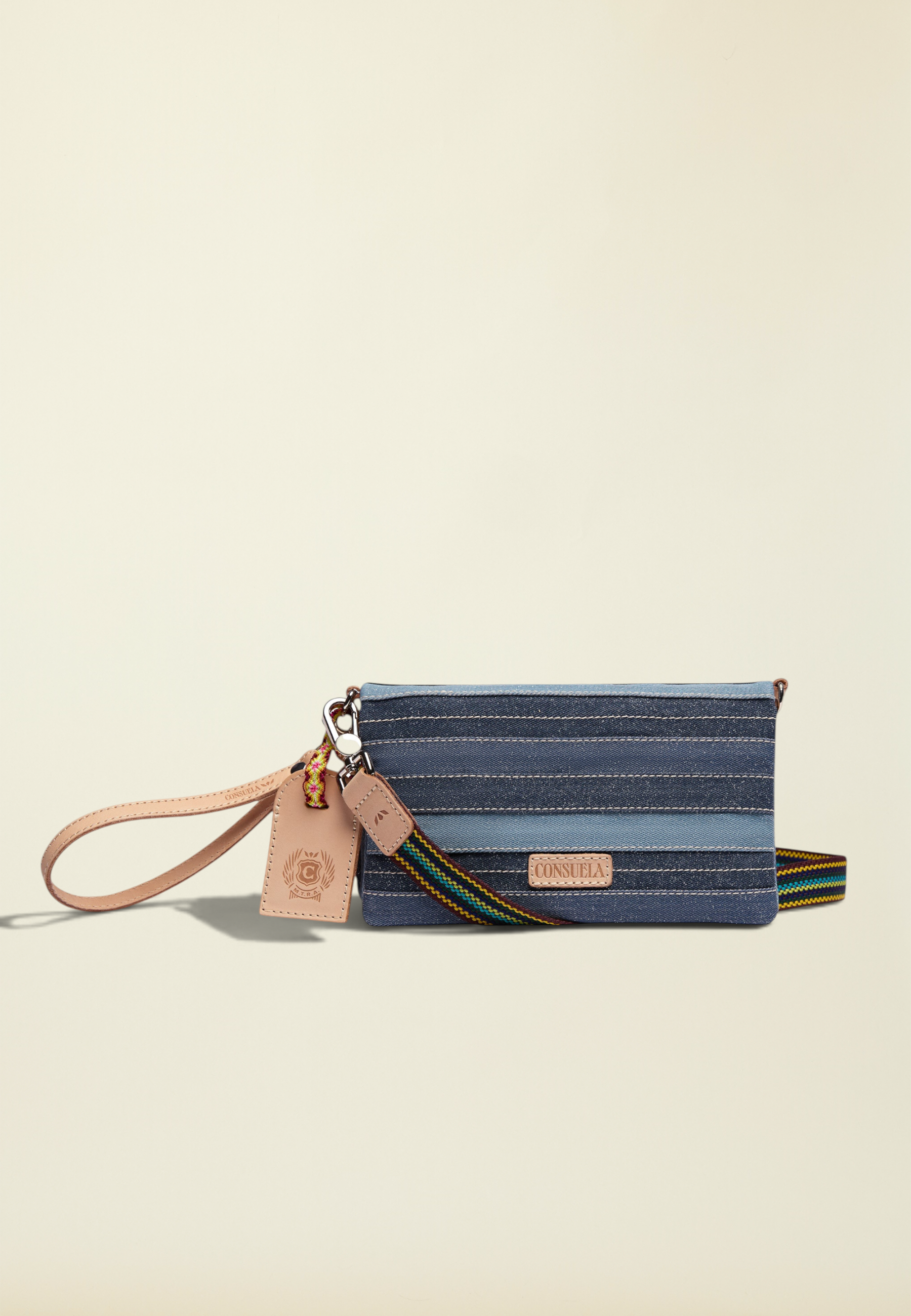 Point of Origin Uptown Crossbody Royal in layered blue denim with natural leather trim and detachable wristlet strap