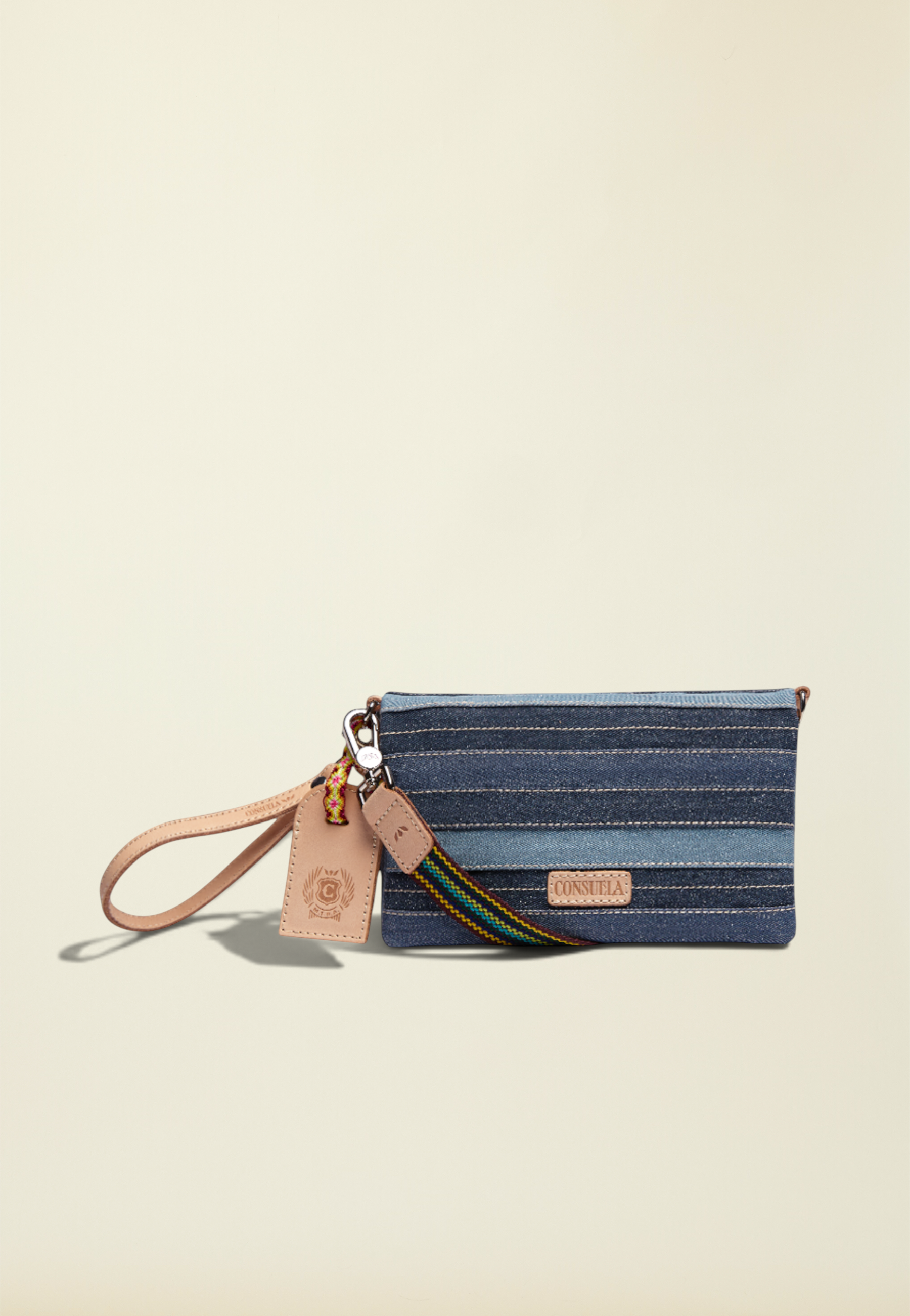 Point of Origin Uptown Crossbody Royal bag in layered blue denim with natural leather trim and wristlet strap.