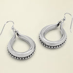 Pair of silver hoop earrings on a white background