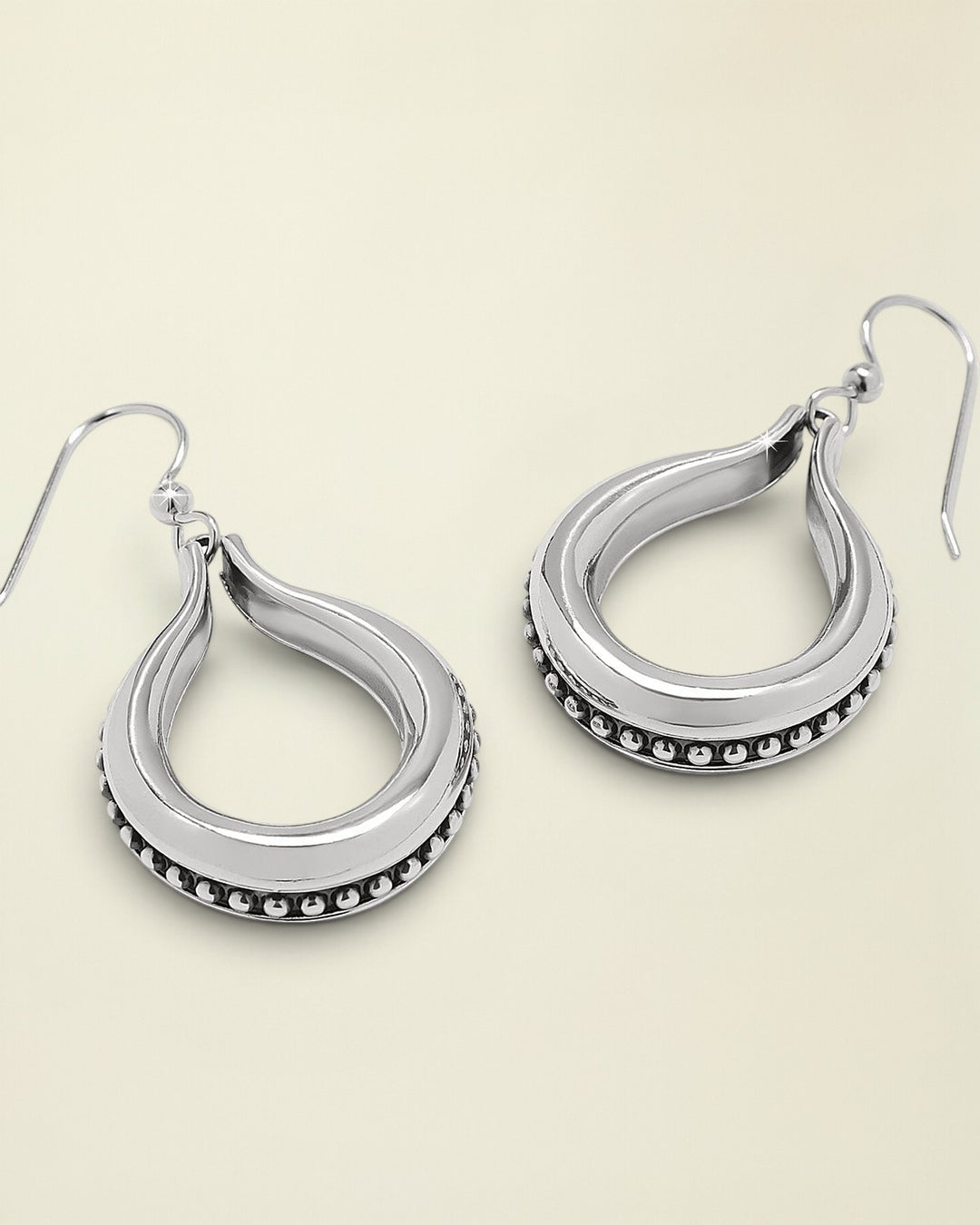 Pair of silver hoop earrings on a white background