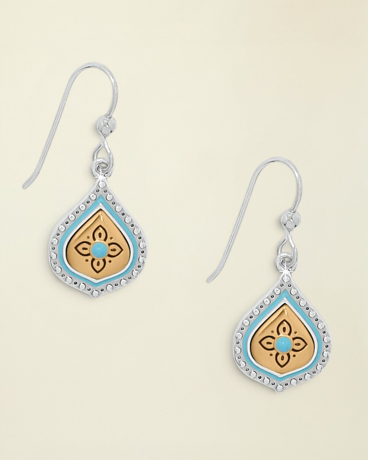 Pair of earrings with decorative designs on a white background