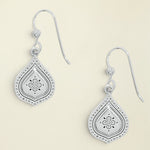 Silver teardrop earrings with floral designs on a white background
