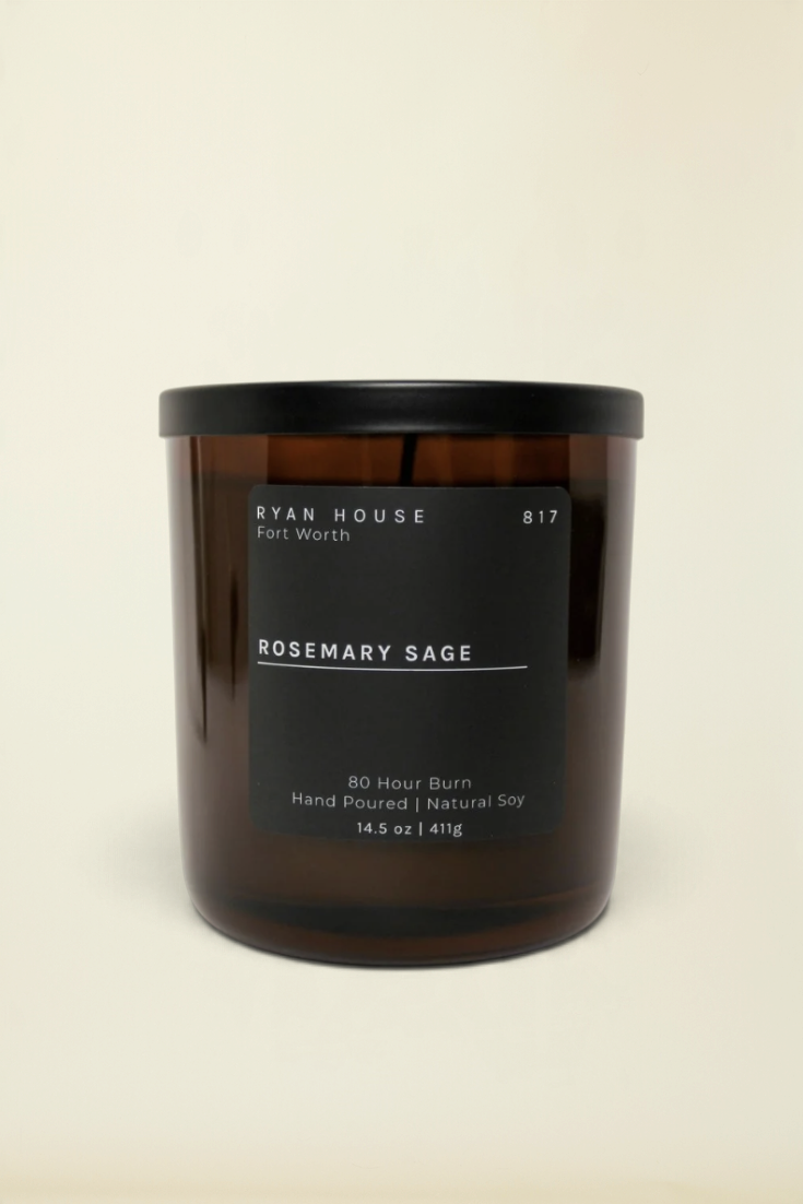 Point of Origin Ryan House Rosemary Sage soy candle in an amber glass jar with a black lid and minimalist label.