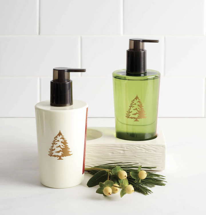 Two soap dispensers, one white and one green, with tree designs on a white background.