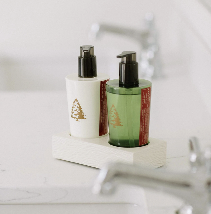 Two bottles with pump dispensers on a white surface, likely in a bathroom setting.