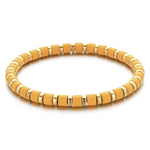 Yellow beaded bracelet with gold accents on a white background