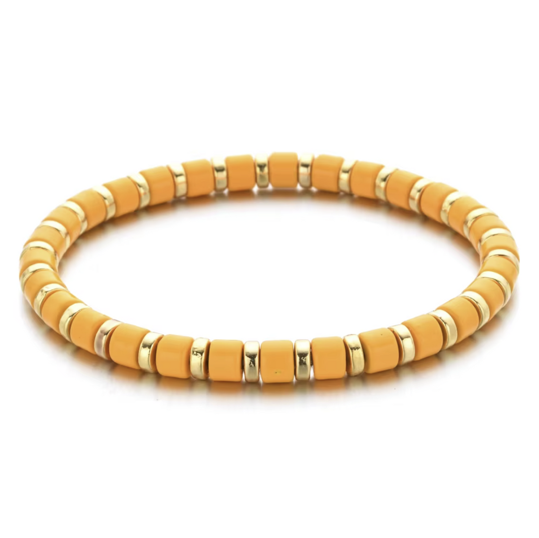Yellow beaded bracelet with gold accents on a white background