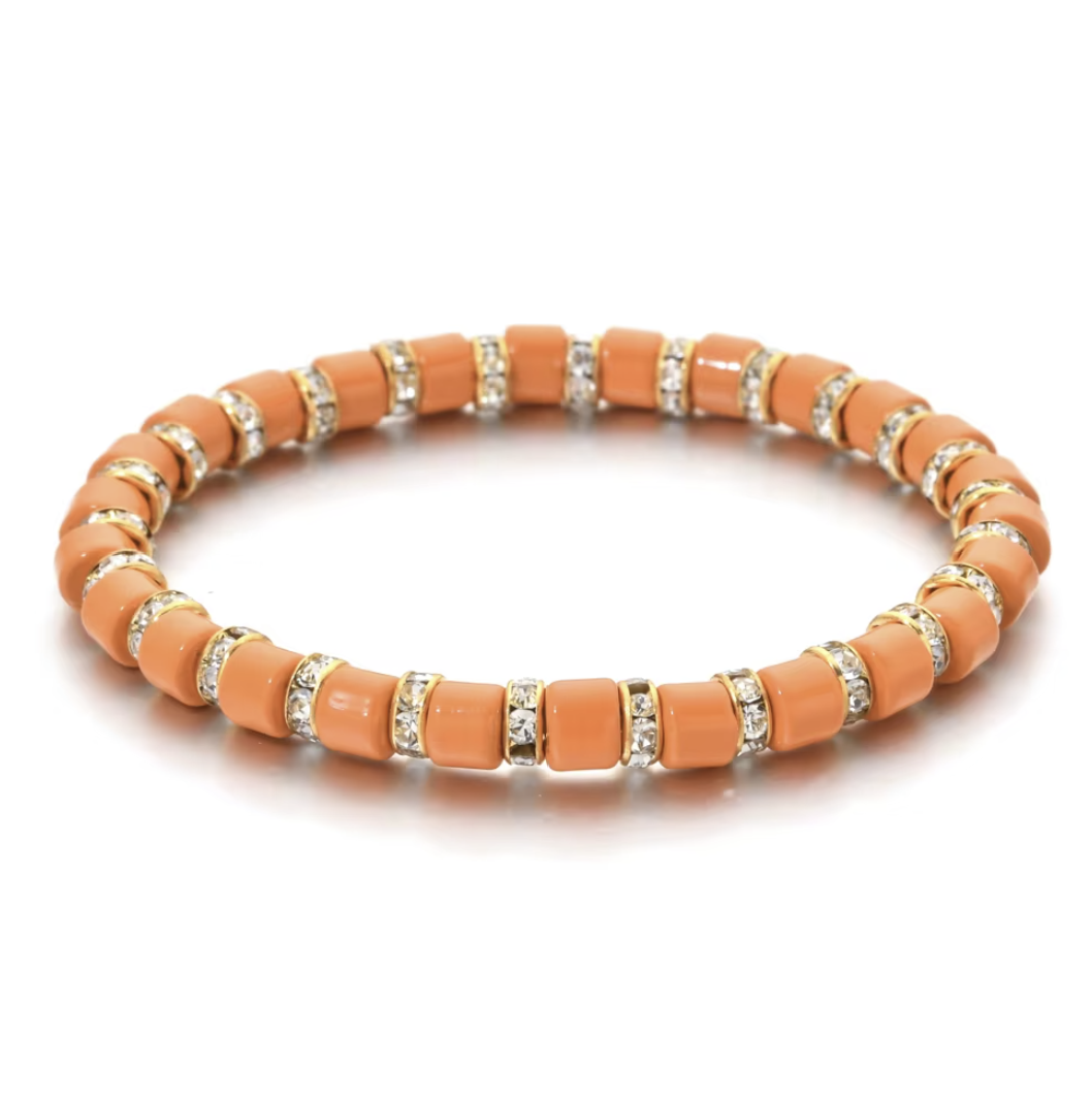 Orange beaded bracelet with small crystals on a white background
