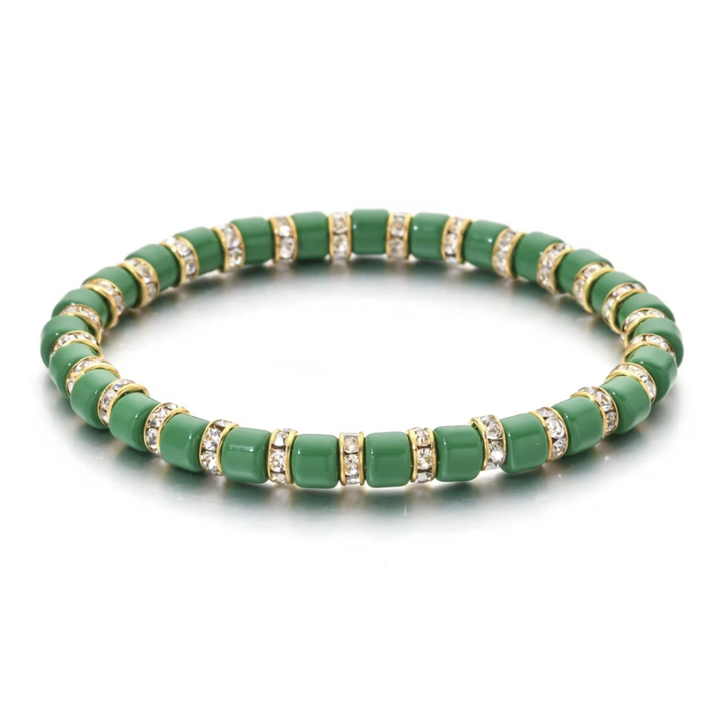 Green beaded bracelet with gold accents on a white background