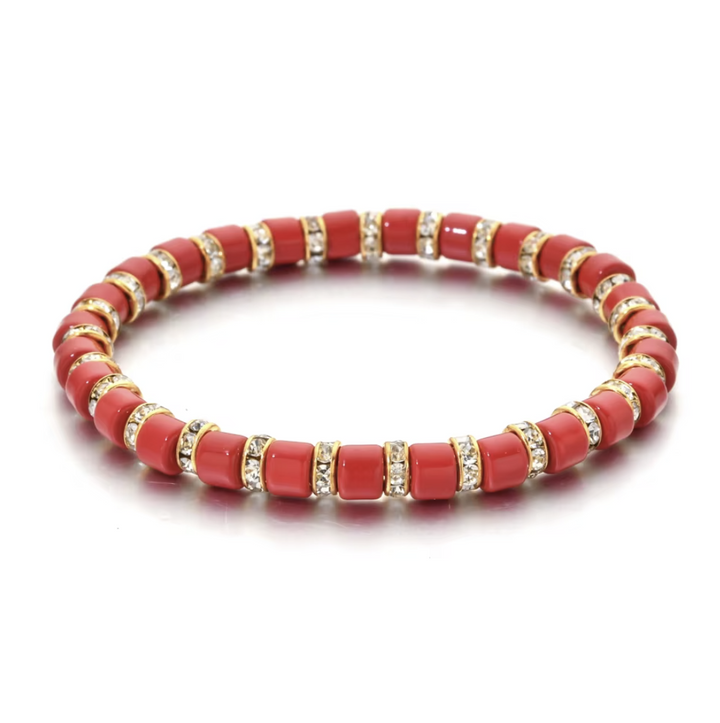 Red beaded bracelet with gold accents on a white background