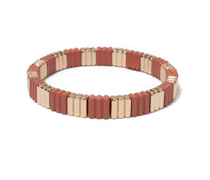 Bracelet with alternating red and gold square beads on a white background