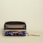 Small wallet with floral pattern and visible brand name on a white background