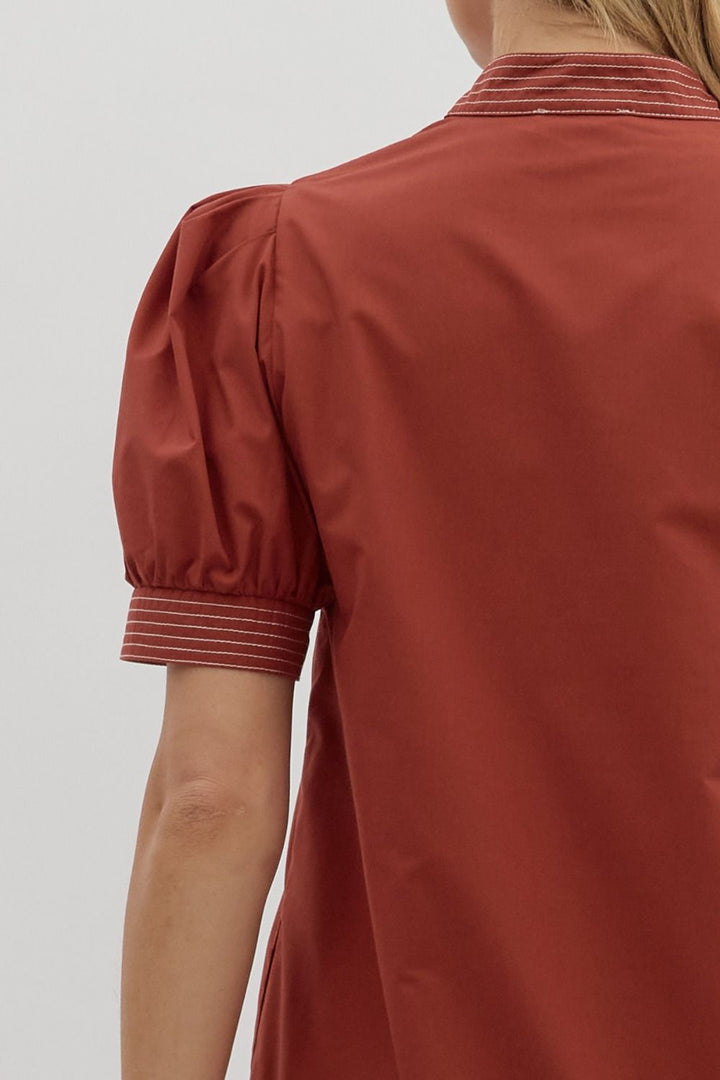 Red blouse with puff sleeves on a plain background