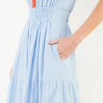 Light blue dress with orange stripe on a white background