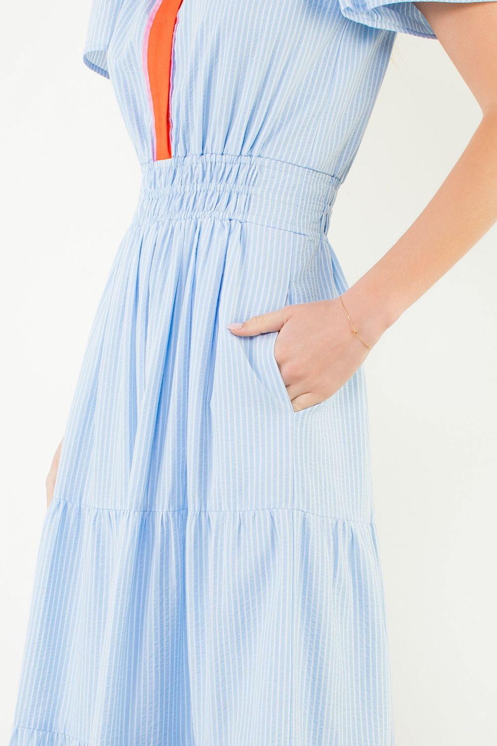 Light blue dress with orange stripe on a white background