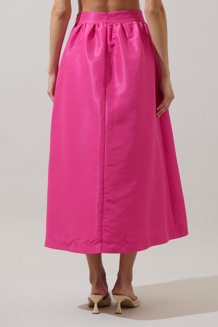 Person wearing a bright pink skirt on a plain background