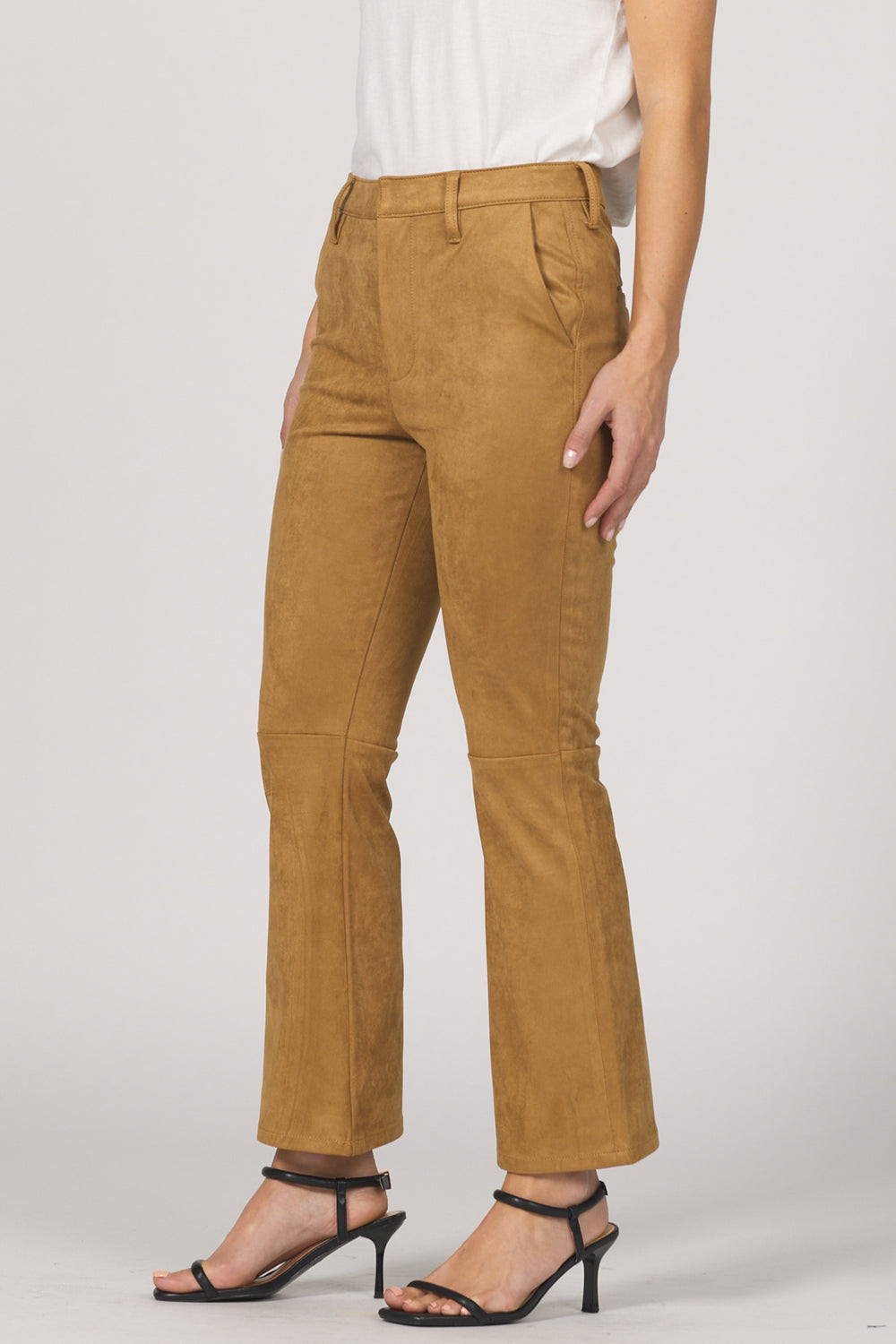 Brown pants worn by a person on a plain background