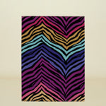 Colorful zebra-striped rug on a white background
