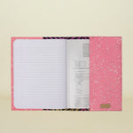 Pink notebook with glittery design on a white background