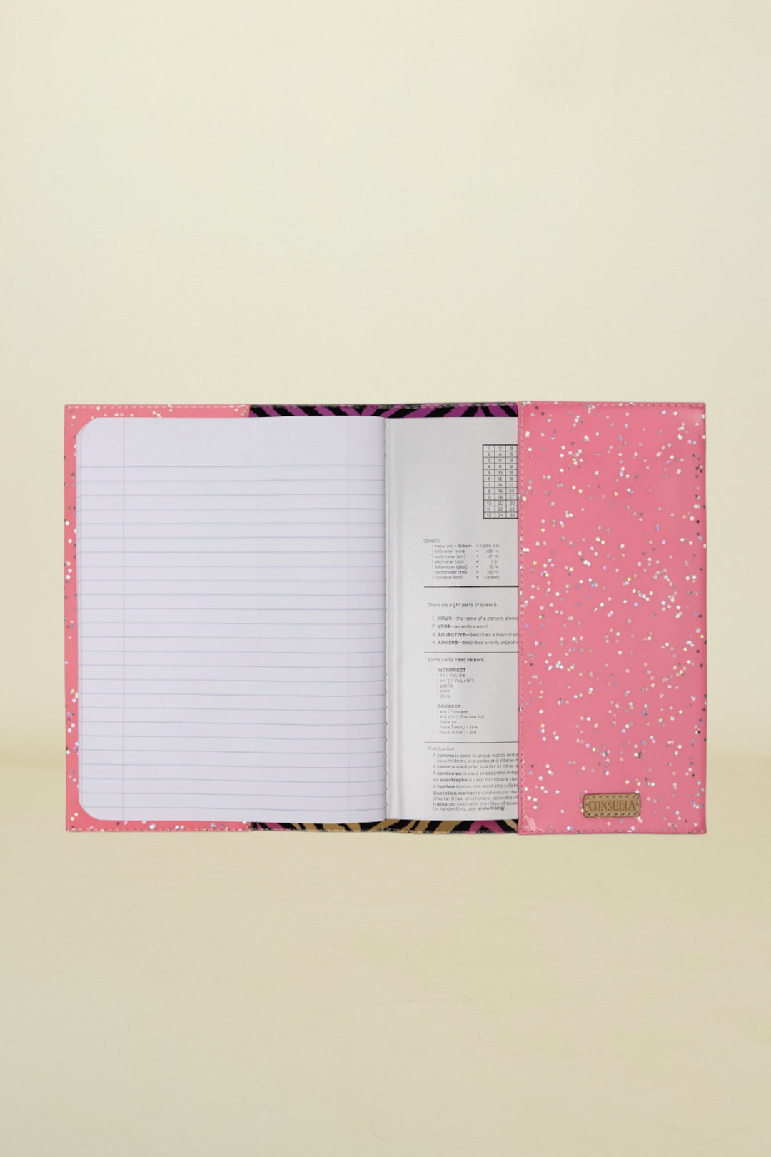 Pink notebook with glittery design on a white background