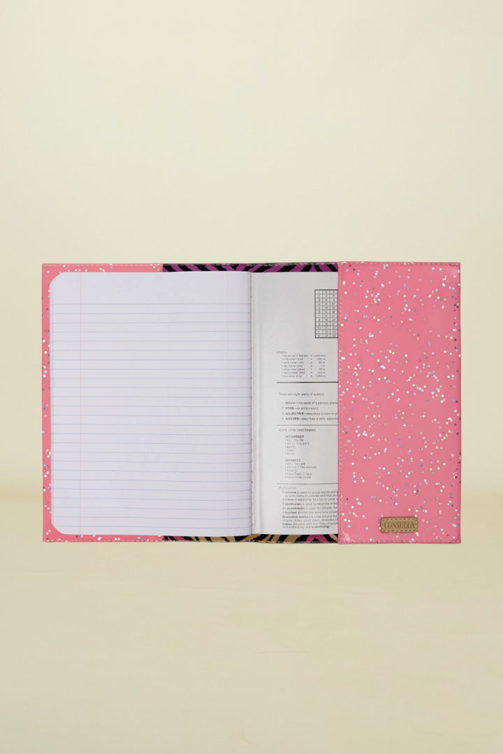 Pink notebook with glittery design on a white background