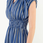 Woman wearing a blue and white striped dress on a white background