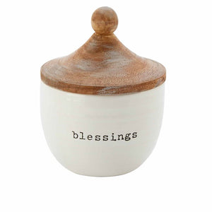 Count your blessings and keep them close with this beautiful jar with debossed sentiment "blessings" stamped into the ceramic covered with a mango wood lid.  Arrives with ten kraft paper heart slips. Size: jar is 6" high and 4 1/2" round. Each heart slip is 2 1/4" x 2 1/2".