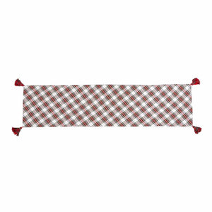 The timeless design of tartan with a "Merry Christmas" accent on one side is designed to work with any style, from traditional to farmhouse to modern. Layer this cotton table runner with all-white dinnerware for a classic look or iconic holiday patterns for a more playful ensemble.   Red tartan "Merry Christmas" runner with tassels reverses to white tartan. Size: 18" x 72" Material: COTTON