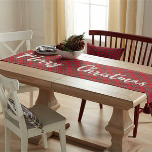 The timeless design of tartan with a "Merry Christmas" accent on one side is designed to work with any style, from traditional to farmhouse to modern. Layer this cotton table runner with all-white dinnerware for a classic look or iconic holiday patterns for a more playful ensemble.   Red tartan "Merry Christmas" runner with tassels reverses to white tartan. Size: 18" x 72" Material: COTTON