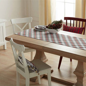 The timeless design of tartan with a "Merry Christmas" accent on one side is designed to work with any style, from traditional to farmhouse to modern. Layer this cotton table runner with all-white dinnerware for a classic look or iconic holiday patterns for a more playful ensemble.   Red tartan "Merry Christmas" runner with tassels reverses to white tartan. Size: 18" x 72" Material: COTTON
