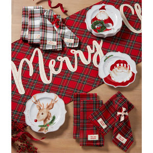 The timeless design of tartan with a "Merry Christmas" accent on one side is designed to work with any style, from traditional to farmhouse to modern. Layer this cotton table runner with all-white dinnerware for a classic look or iconic holiday patterns for a more playful ensemble.   Red tartan "Merry Christmas" runner with tassels reverses to white tartan. Size: 18" x 72" Material: COTTON