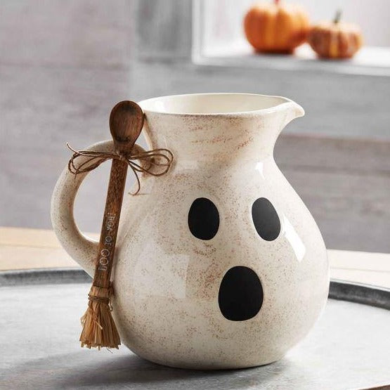 2-piece set. Ceramic ghost pitcher arrives with printed wood raffia "broom" spoon.  Size: pitcher 96 oz | spoon 6 1/4"