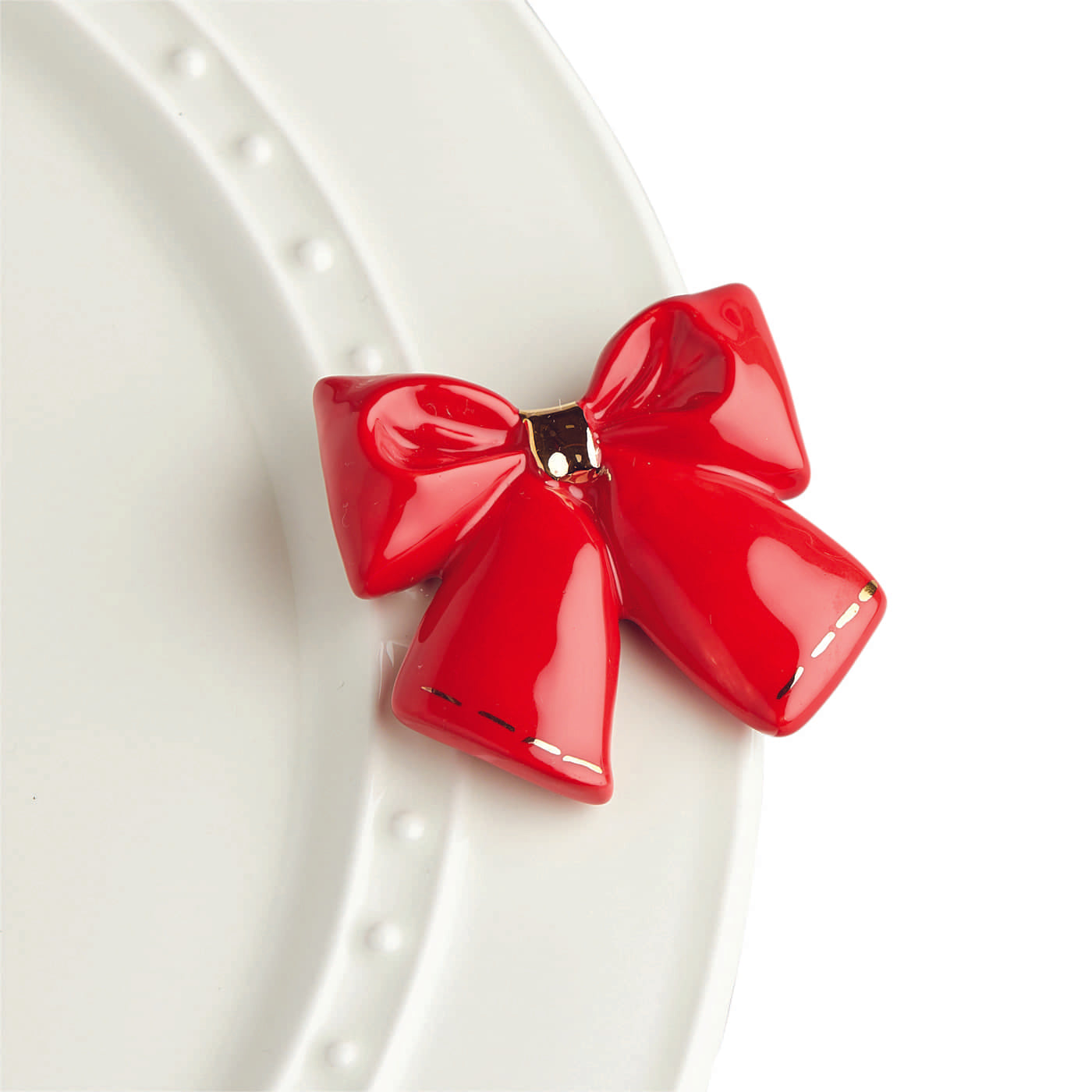 Your base pieces plus a crisp red bow mini make a complete package!  With Nora Fleming serving platters and minis you can dress up your dinnerware with interchangeable pieces for everyday serving. Add any Nora Fleming Mini to your favorite Nora Fleming platter or base for easy entertaining and for every occasion!  not dishwasher safe hand wash only ceramic coordinates with all Nora Fleming pieces