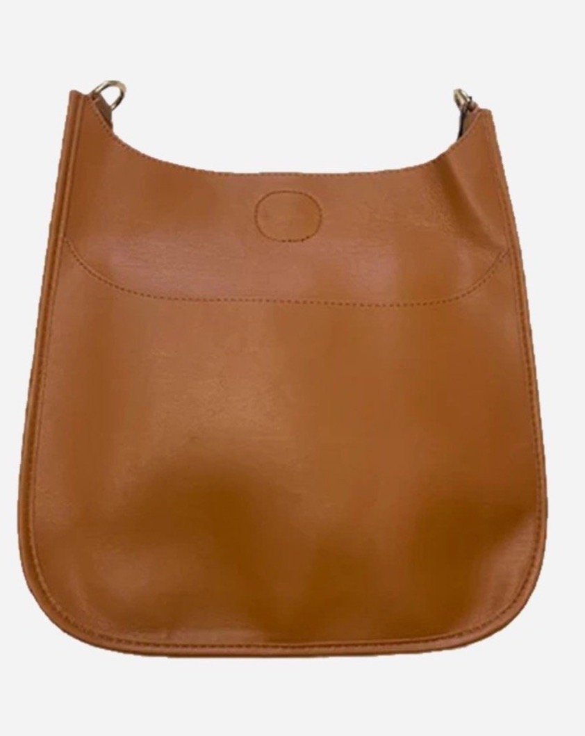Grab this season's top selling bag, perfect for every fashion-forward lover! This unique soft faux leather bag is for women on the go and is right by your side to stash everything you need, from sunglass to your favorite lipstick. Customize to your style! Pair with the strap of your choice for a custom look.  Details: No strap attached Faux Leather design External front pocket Snap top closure Measures approx. 13" H x 12" W x 3" D