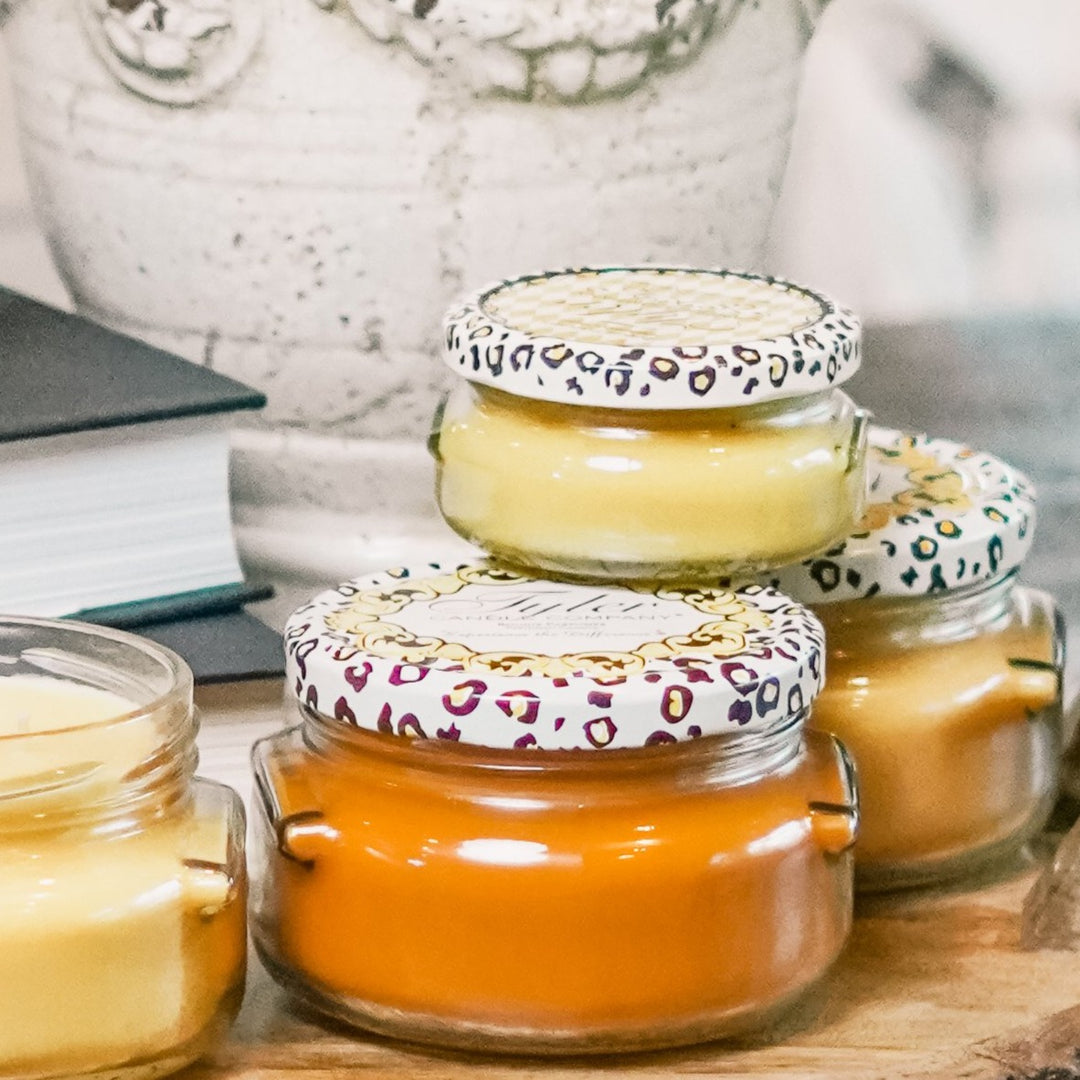Say hello to fall with the Tyler Candle Company. Their unique blend of soy and paraffin wax has produced one of the finest scented candles on the market. Tyler uses the finest quality waxes and opulent fragrance oils available to create the ultimate aroma experience. Each candle is hand-poured, ensuring even burning and maximum fragrance saturation. All jars are guaranteed to fragrance a room in minutes!  Choose from the following scents:   Homecoming Mulled Cider Pumpkin Spice