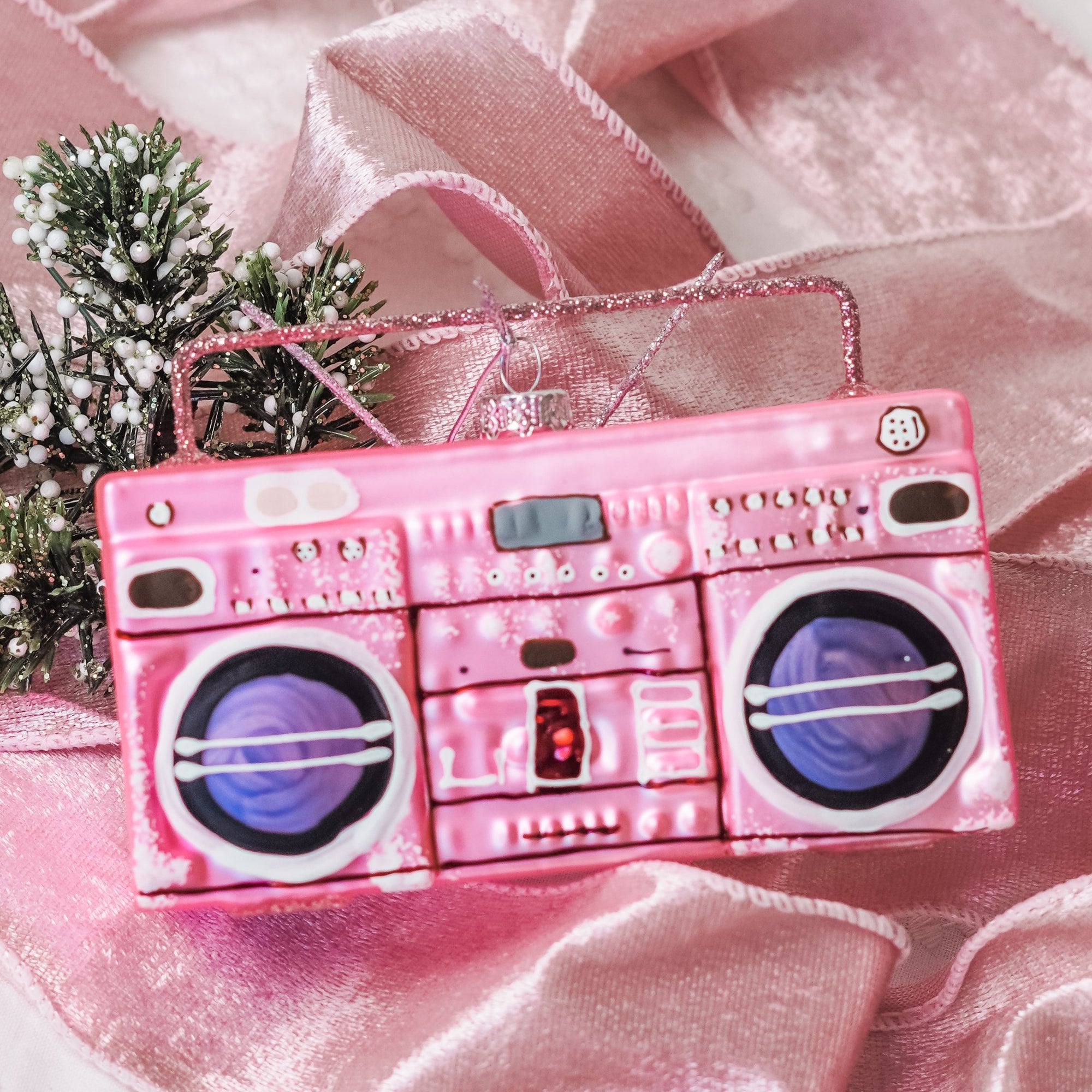 Remember when you and your girlfriends got your groove on to tunes booming out of your boombox? Celebrate the season with this nostalgic Boombox Ornament in Pink - a wonderful addition to your Christmas ornament collection this year!  Approximately 5 in. wide by 3 in. tall Made of glass.  Imported.