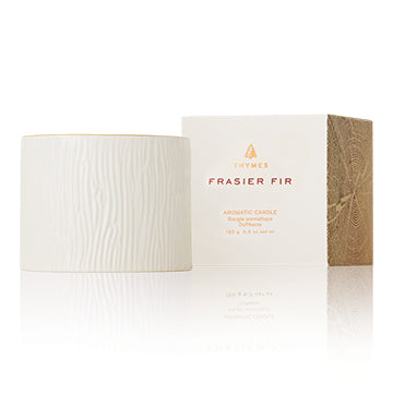 This aromatic candle features stunning wintery white wood grain ceramic, trimmed with a 24-karat gold rim. The fresh, just-cut forest fragrance of Frasier Fir fills any room with warmth and elegant ambiance.  Non-metal wick provides a clean, pure burn. Approximately 45 hours.