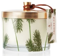 A holiday favorite, dressed up and ready to fill your home with the mountain fresh scent of Frasir Fir. Snow-white wax poured into clear glass, embellished with the classic pine needle design and iconic green hues is truly a glowing focal point with its gold metal lid and hang tag.   Non-metal wick provides a clean burn. 11.5 oz.